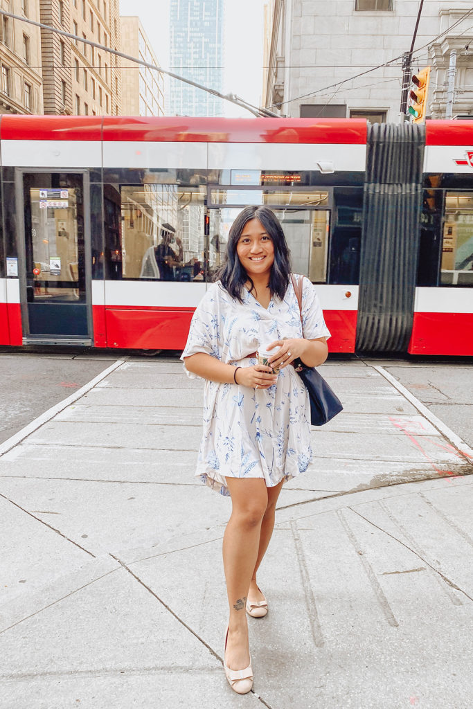 Canadian lifestyle and mommy blogger, Lisa Favre, posing in front of a TTC train car