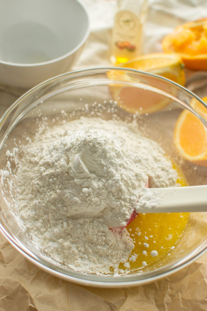 Mixing bowl with flour and ingredients for orange cookie bars batter