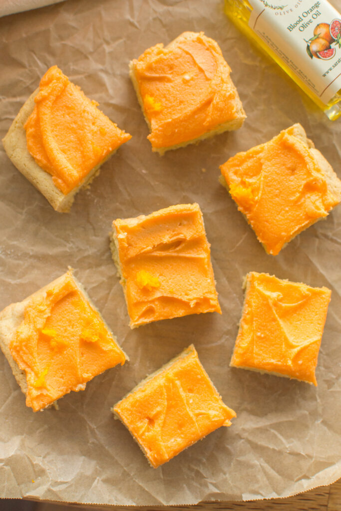Freshly baked Orange Creamsicle Cookie Bars cut into bite-sized slices