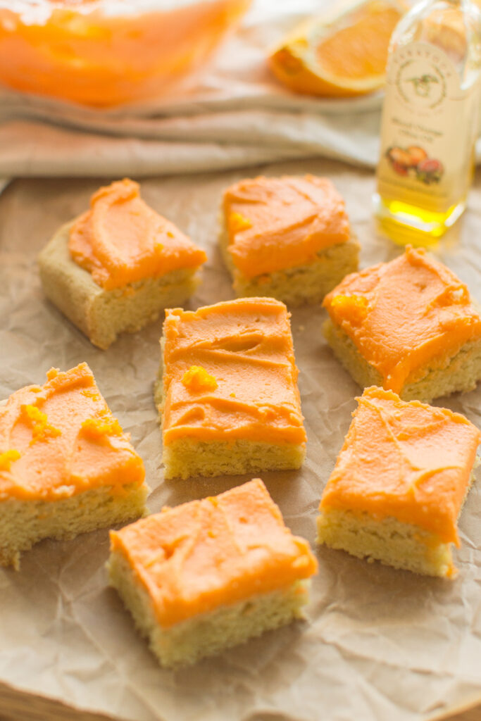 Cut Orange Creamsicle Cookie Bars arranged on parchment paper
