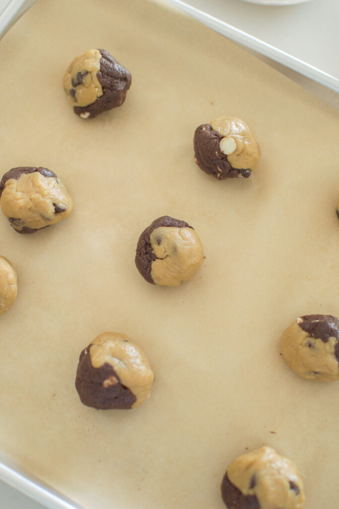 Close-up of half chocolate half vanilla cookie dough balls before baking