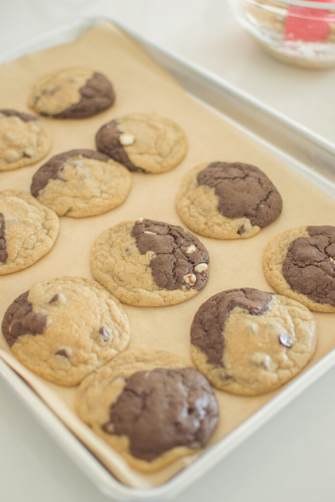 Freshly baked marbled chocolate and vanilla cookies cooling on baking sheet