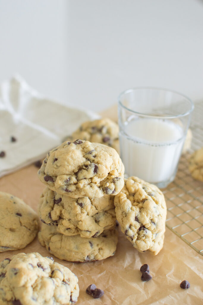 Bakery-style oversized chocolate chip cookies on wooden serving board