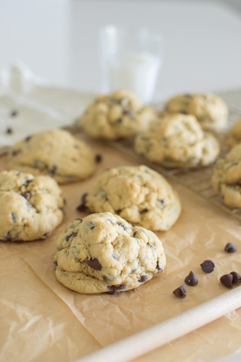 Homemade oversized chocolate chip cookies served with milk